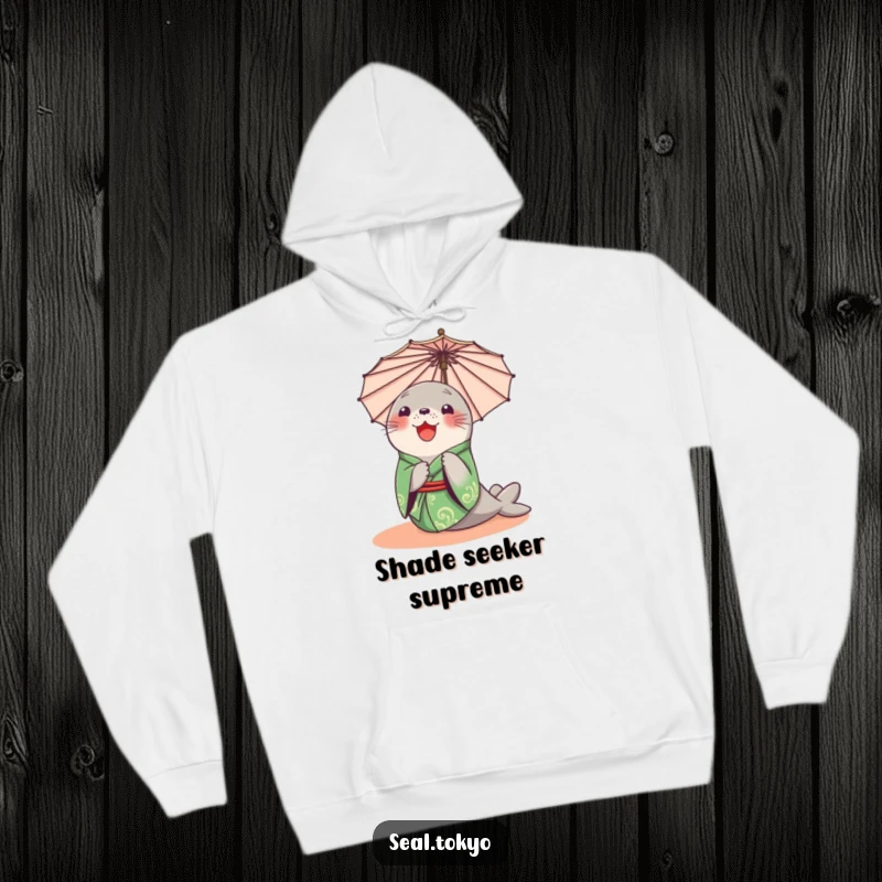 Funny Seal Hoodie: A delighted cartoon seal in a green kimono, curiously peeking from behind a parasol, perfect for cozy moments.