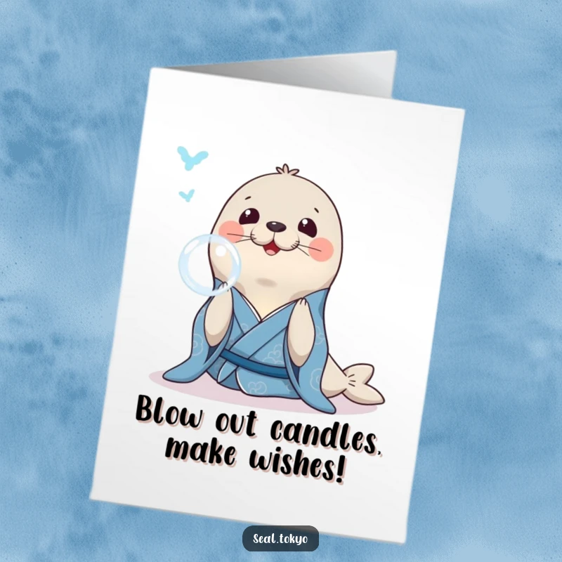 Funny Free Printable Birthday Card: Smiling seal in a blue kimono gracefully blowing a perfect bubble ring, celebrating.