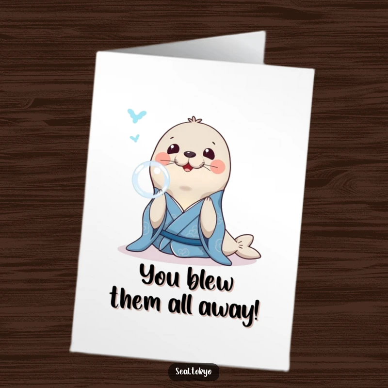 Funny Free Printable Congratulations Card: A smiling seal in a blue kimono blowing a bubble ring, signifying success.